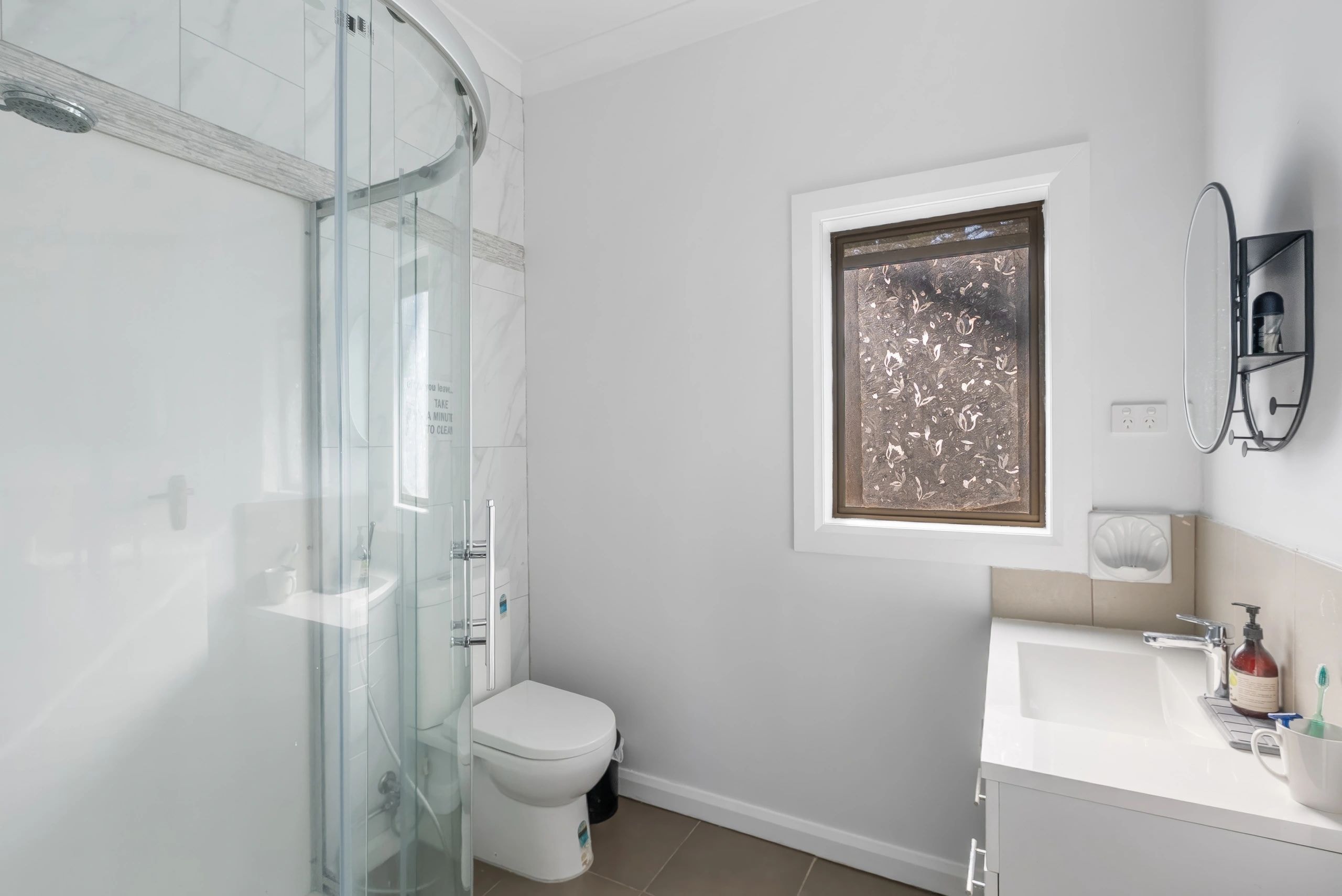 Bathroom with curved shower enclosure