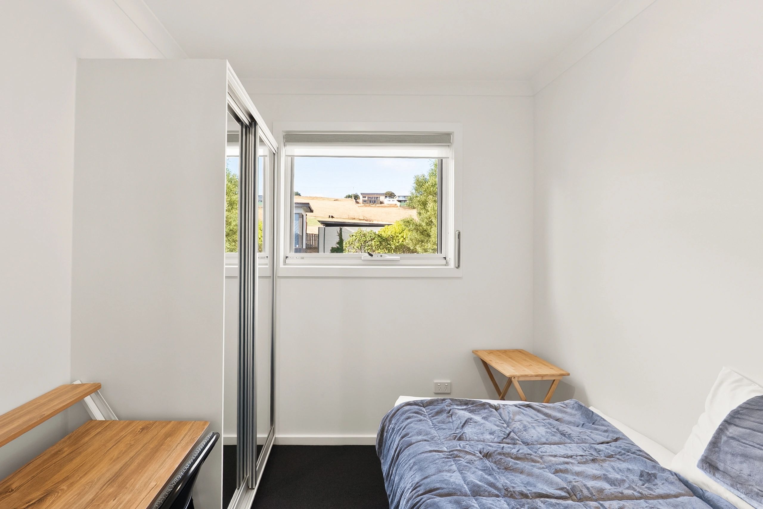 Bedroom with wardrobe and rural views
